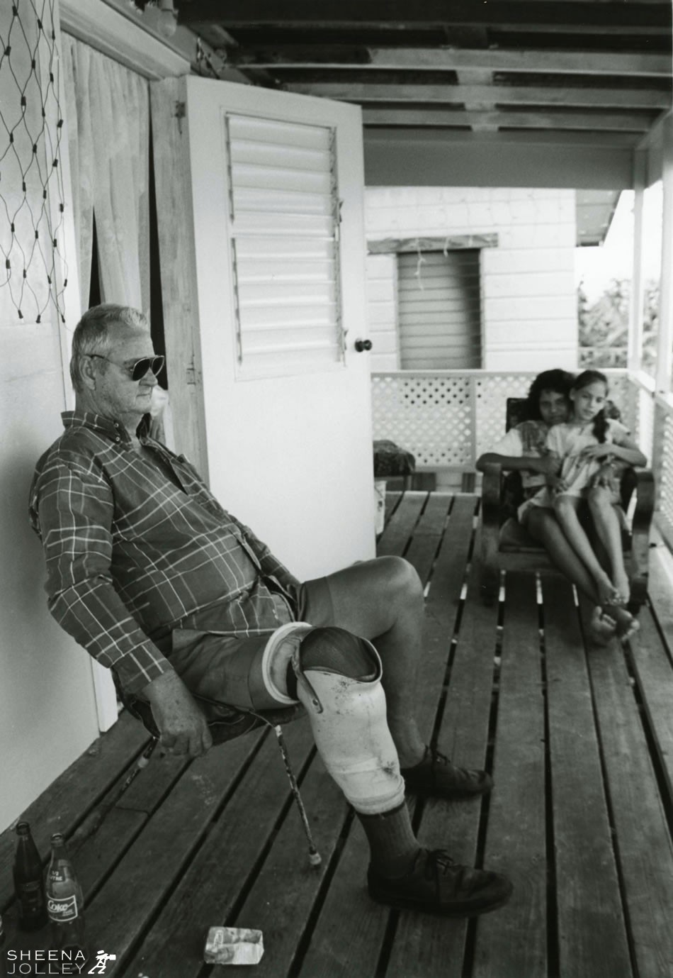 Redlegs John Farnum and Shontelle taken on the verandah of a chattel house in Newcastle, St John, Barbados. John has diabetes, has had one leg amputated and is losing his sight.
