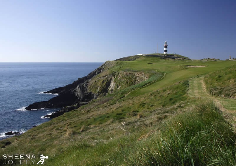 The Old Head Lighthouse, Kinsale, Co Cork, Ireland with the golf links in the fioreground. It is a windswept site which has to close in the winter.